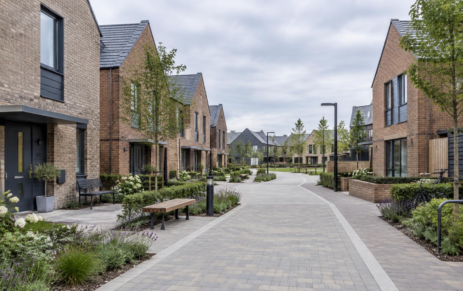 Contemporary brick homes arranged around a landscaped pedestrian street